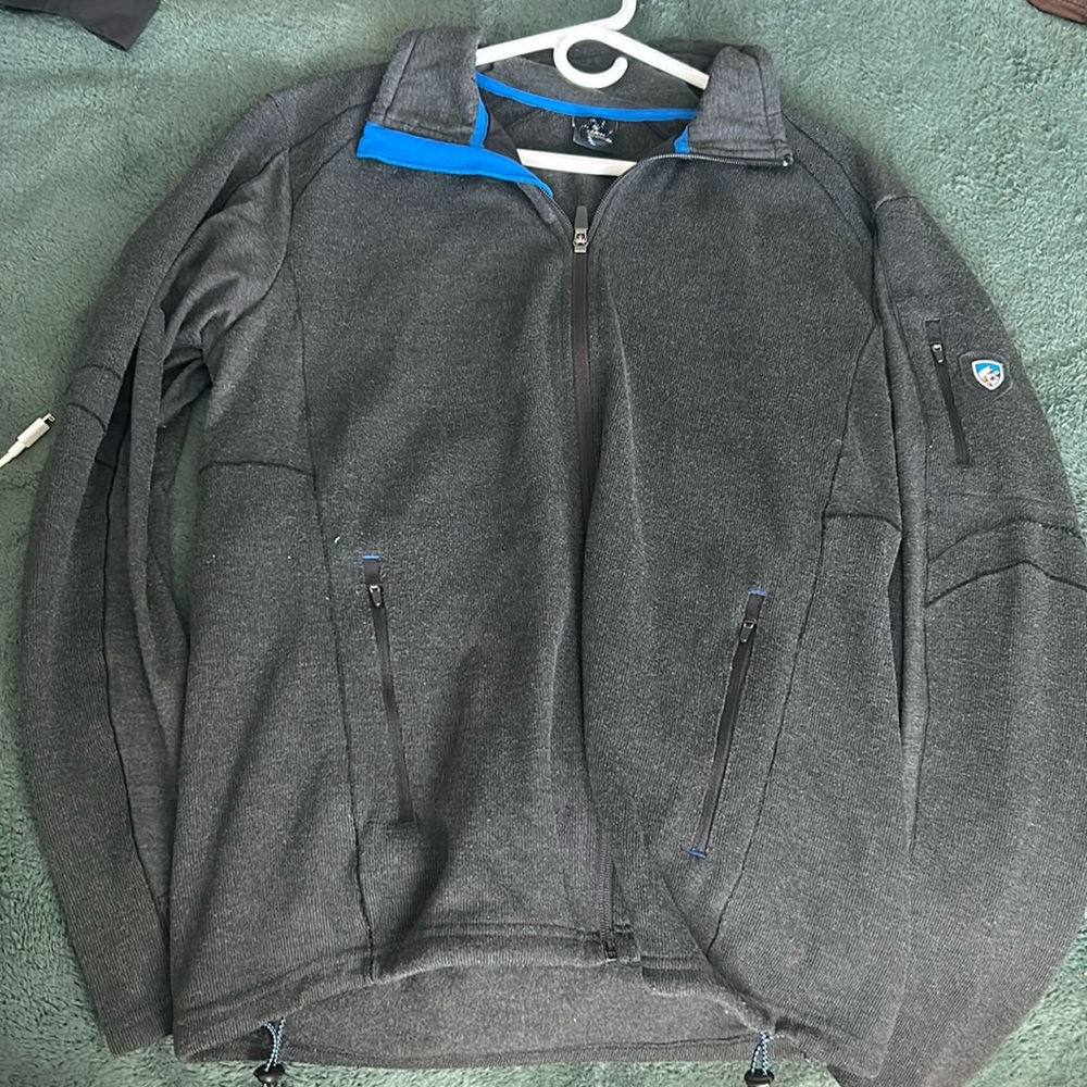 Dark grey Kühl jacket with blue trip